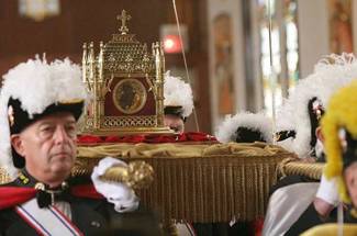 A Knights of Columbus honor guard processes with a reliquary containing the incorrupt heart of St John Vianney at Cure of Ars Church in Merrick, New York 